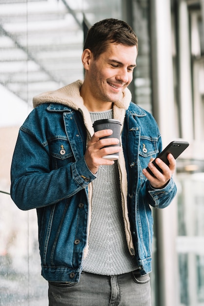 Modern man with coffee cup in urban environment