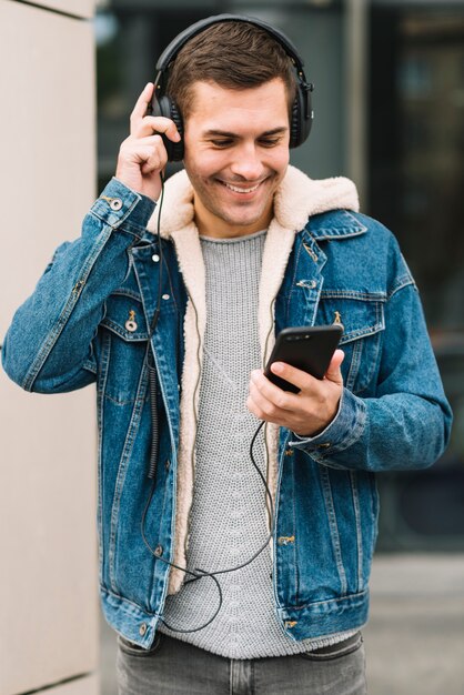 Modern man with headphones in urban environment