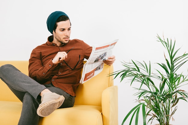 Free Photo modern man with newspaper on the sofa