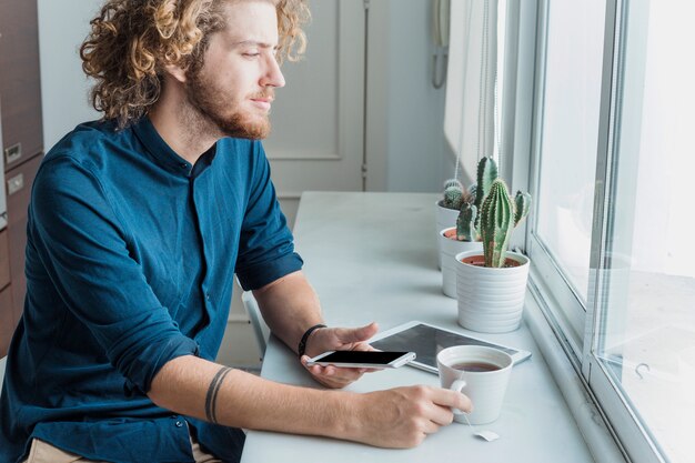 Modern man with smartphone and tablet