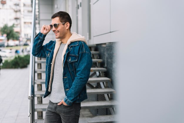 Modern man with sunglasses in city