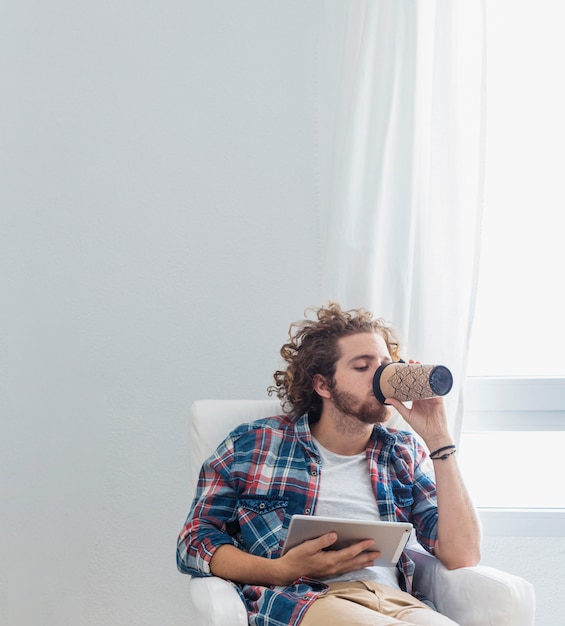 Modern man with table on couch