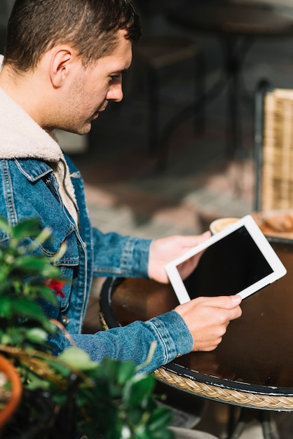 Free Photo modern man with tablet in urban environment