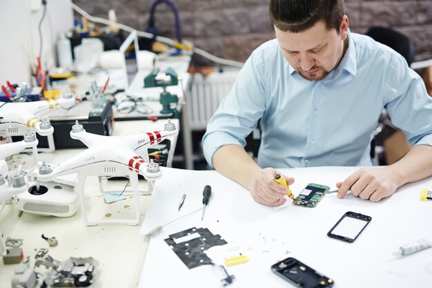 Modern Man Working in Electronics Service Shop