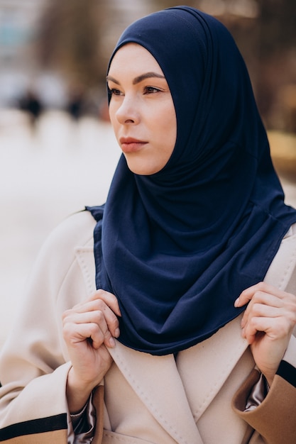 Modern muslim woman wearing headscarf walking in the street