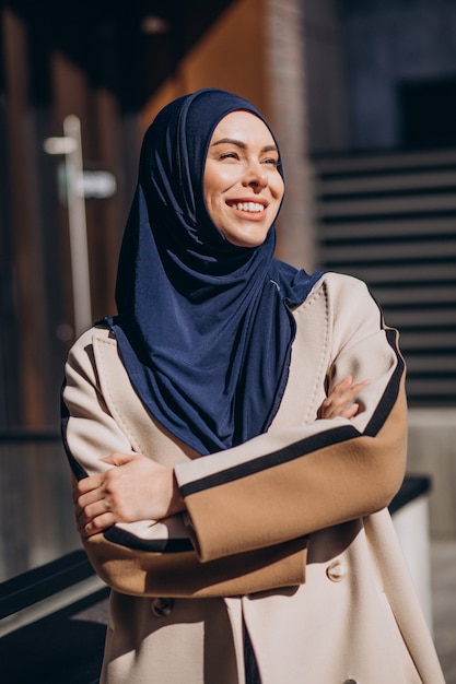 Modern muslim woman wearing headscarf walking in the street