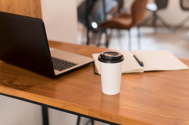 Free Photo modern office desk with cup of coffee