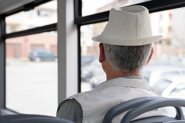 Free photo modern senior man sitting in the bus