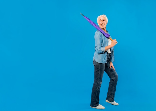 Modern senior woman with umbrella