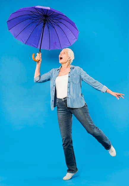 Modern senior woman with umbrella