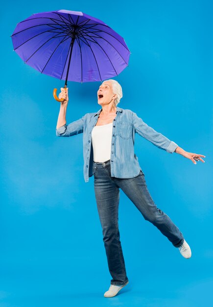 Modern senior woman with umbrella