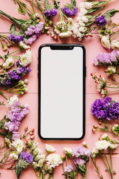 Free Photo modern smartphone and arranged flowers