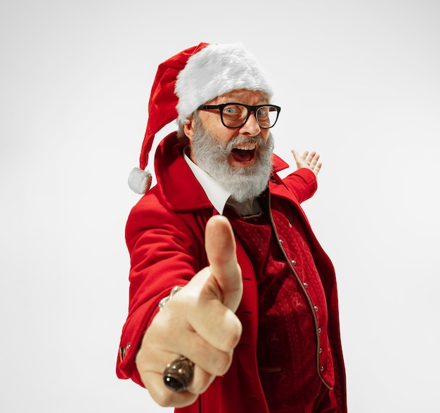 Free Photo modern stylish santa claus in red fashionable suit and cowboy's hat