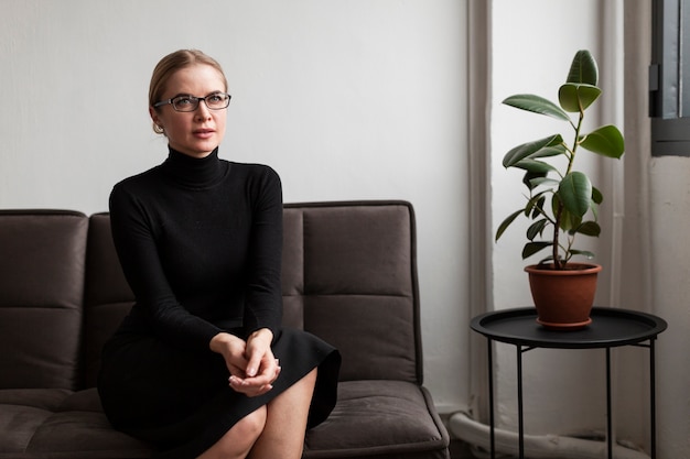 Modern woman on couch looking at camera