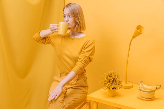 Modern woman drinking from a mug