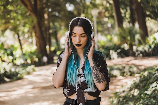 Free photo modern young woman enjoying music on white headphone