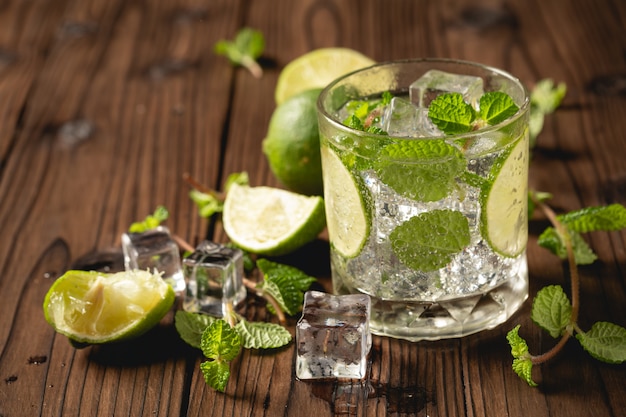 Mojito cocktail on wooden table.