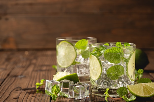 Mojito cocktail on wooden table.