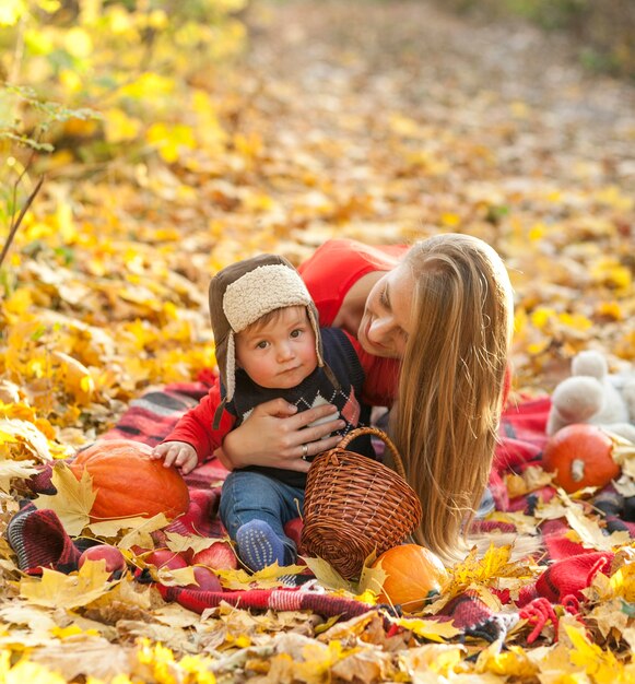 Mom and baby sitting on a picnic blanket