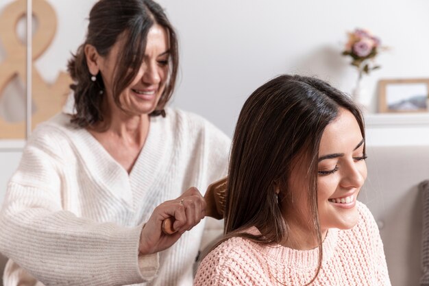 Mom combing daughter hair