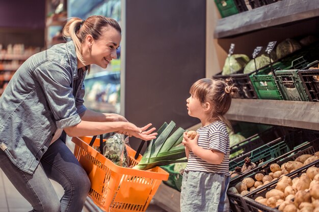 Mom and daughter are shopping at the supermarket