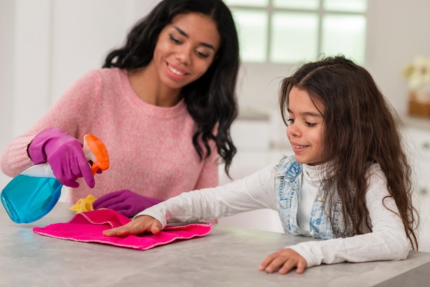 Mom and daughter cleaning house