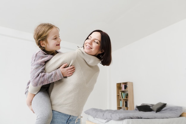 Mom giving piggyback ride to daughter