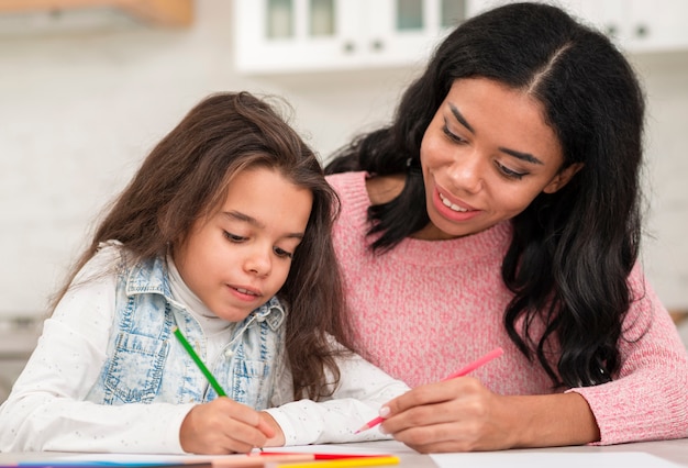 Mom helping daughter with homeworks