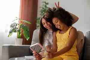 Free photo mom helping her child styling afro hair