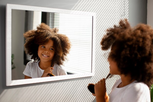 Mom helping her child styling afro hair