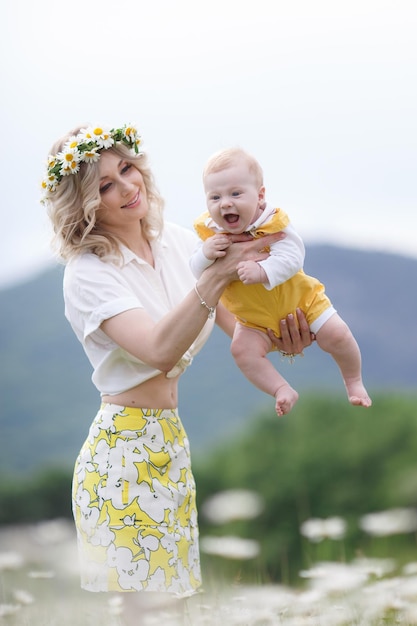 Free photo mom and her kid in camomile field