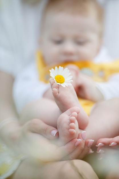 Free photo mom and her kid in camomile field