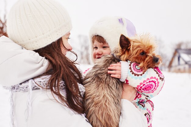 Mom holds her daughter and doggy