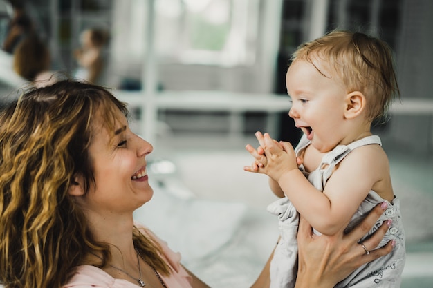 mom hugs and kisses little son