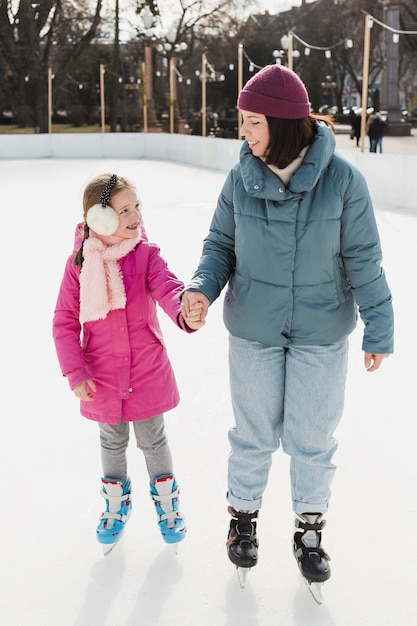 Free photo mom and kid ice skating