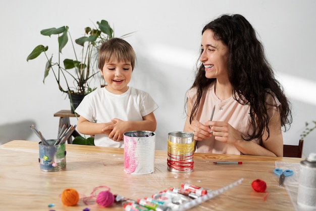 Mom showing kid how to reuse materials in creative ways