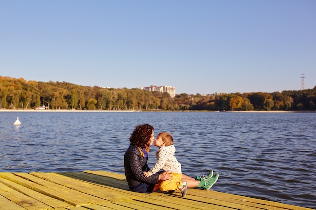 Mom and son resting by the lake