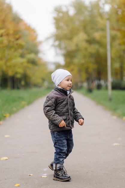 Mom and son walking and having fun together in the autumn park.