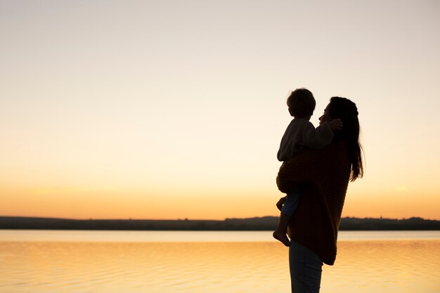 Mom spending time with kid at the beach