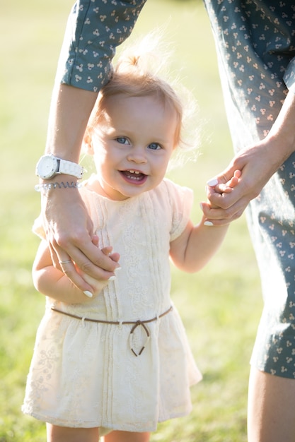 Free photo mom teaching tot daughter to walk