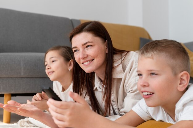 Mom watching television with her children