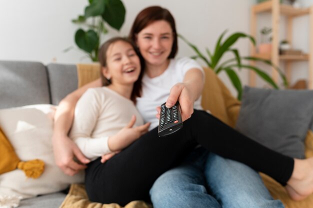 Mom watching television with her children