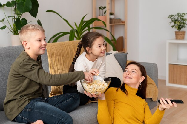 Mom watching television with her children