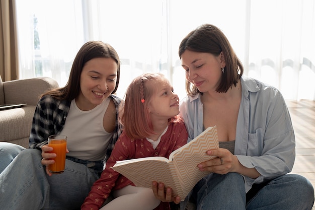 Mommies spending time together with their daughter indoors