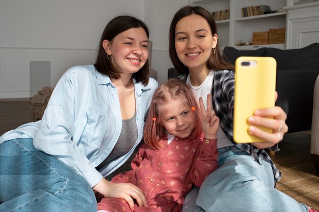 Mommies spending time together with their daughter indoors