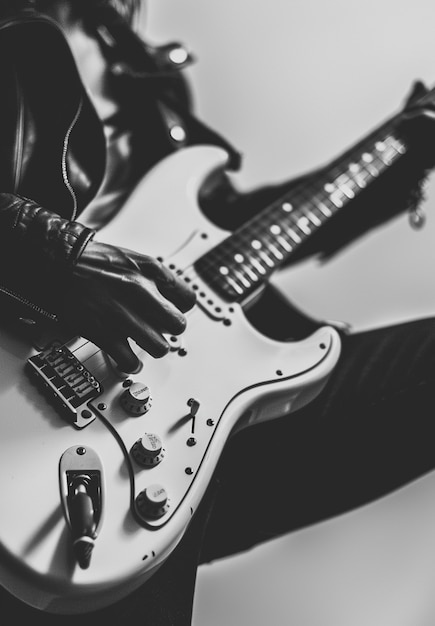 Monochrome view of person playing electric guitar