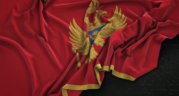 Free photo montenegro flag wrinkled on dark background 3d render