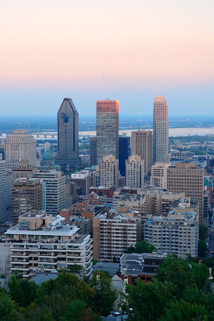 Montreal city skyline at sunset viewed from Mont Royal with urban skyscrapers.