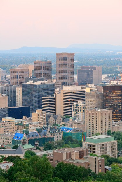 Montreal city skyline at sunset viewed from Mont Royal with urban skyscrapers.