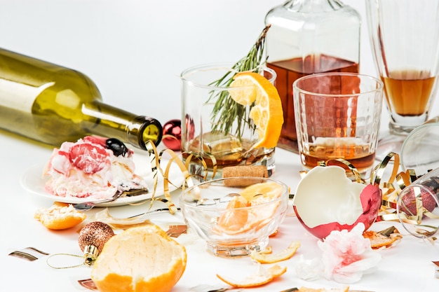 Free Photo the morning after christmas day, table with alcohol and leftovers